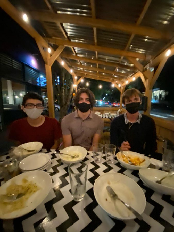 We caught our friends – Sean Khanna (left), Noah Gilbertson (center), Sam Roach (right) – after finishing their meals in an awkward fish-eye photo. Photo taken by Claire Roach.