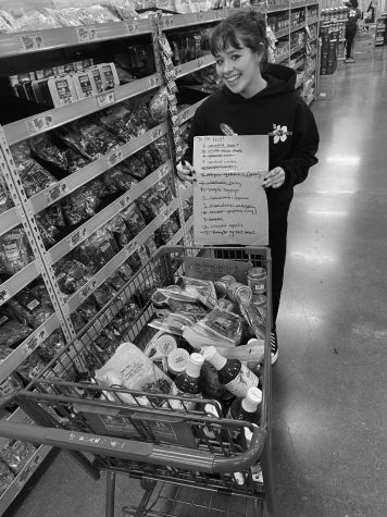 Trader Joes employee and The Wolf staff member Tullia Salboro working hard to restock shelves at the new Tigard location. Photograph by Timmy Parsons.