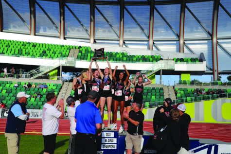 Rob Ayers photographing the Tualatin girls celebrate after winning first-ever state championship,
making history for Tualatin Track & Field.