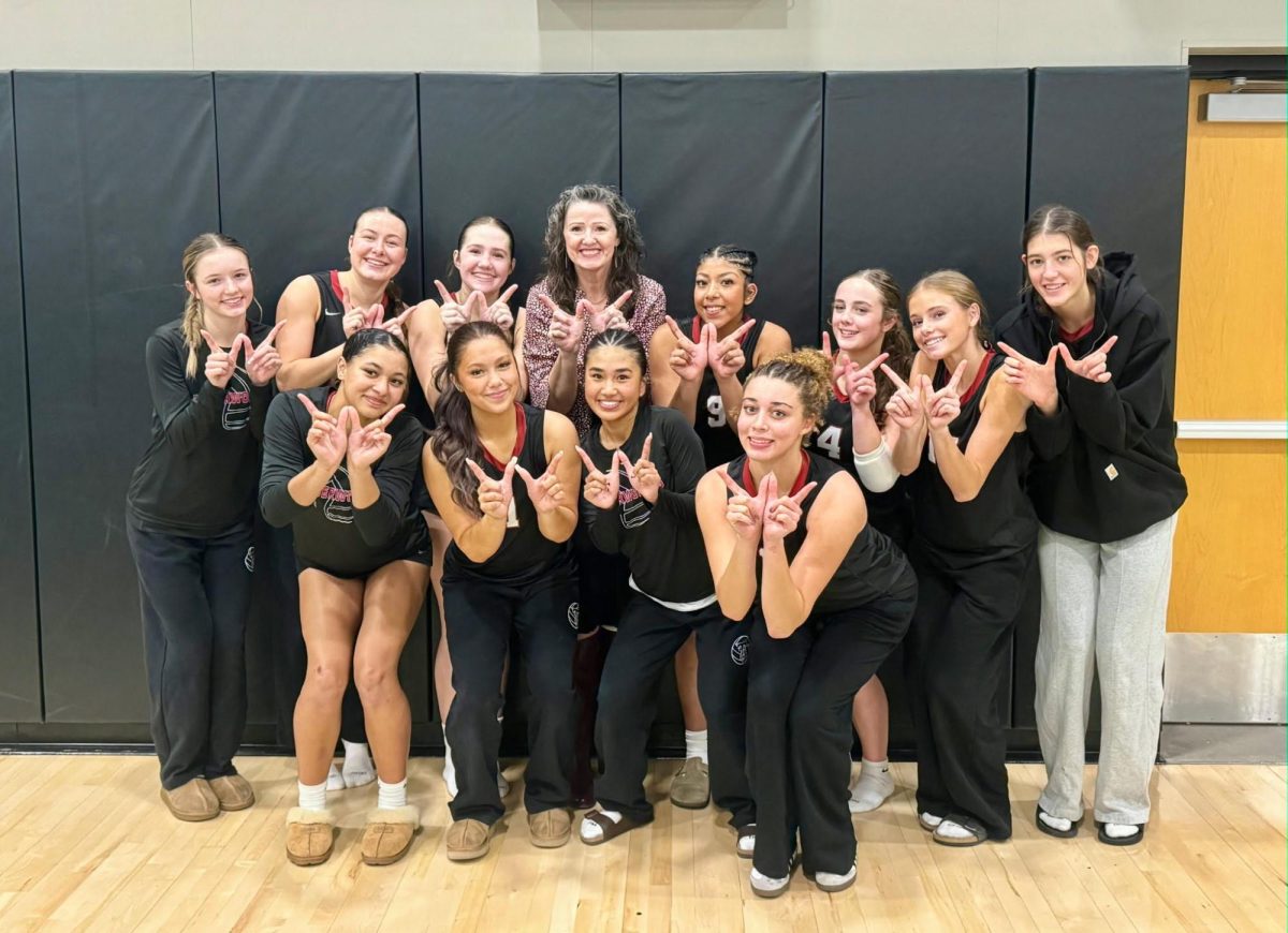 Tualatin varsity volleyball players gathered to celebrate after beating Tigard.