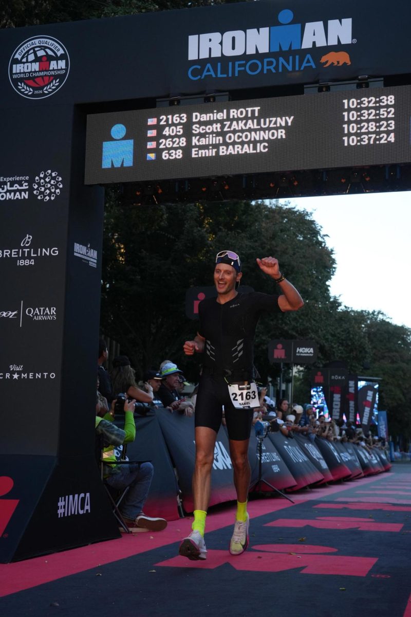Science teacher Dan Rott runs through the finish line at the end of his IRONMAN competition in October.